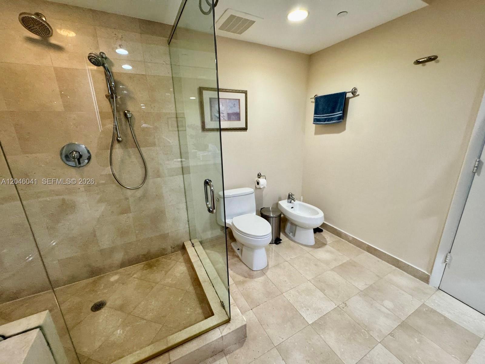 A bathroom features a glass-enclosed shower, a toilet, and a bidet with tiled floors — 1830 S Ocean Dr # 4806, Hallandale Beach FL 33009, HALLANDALE BEACH, FL