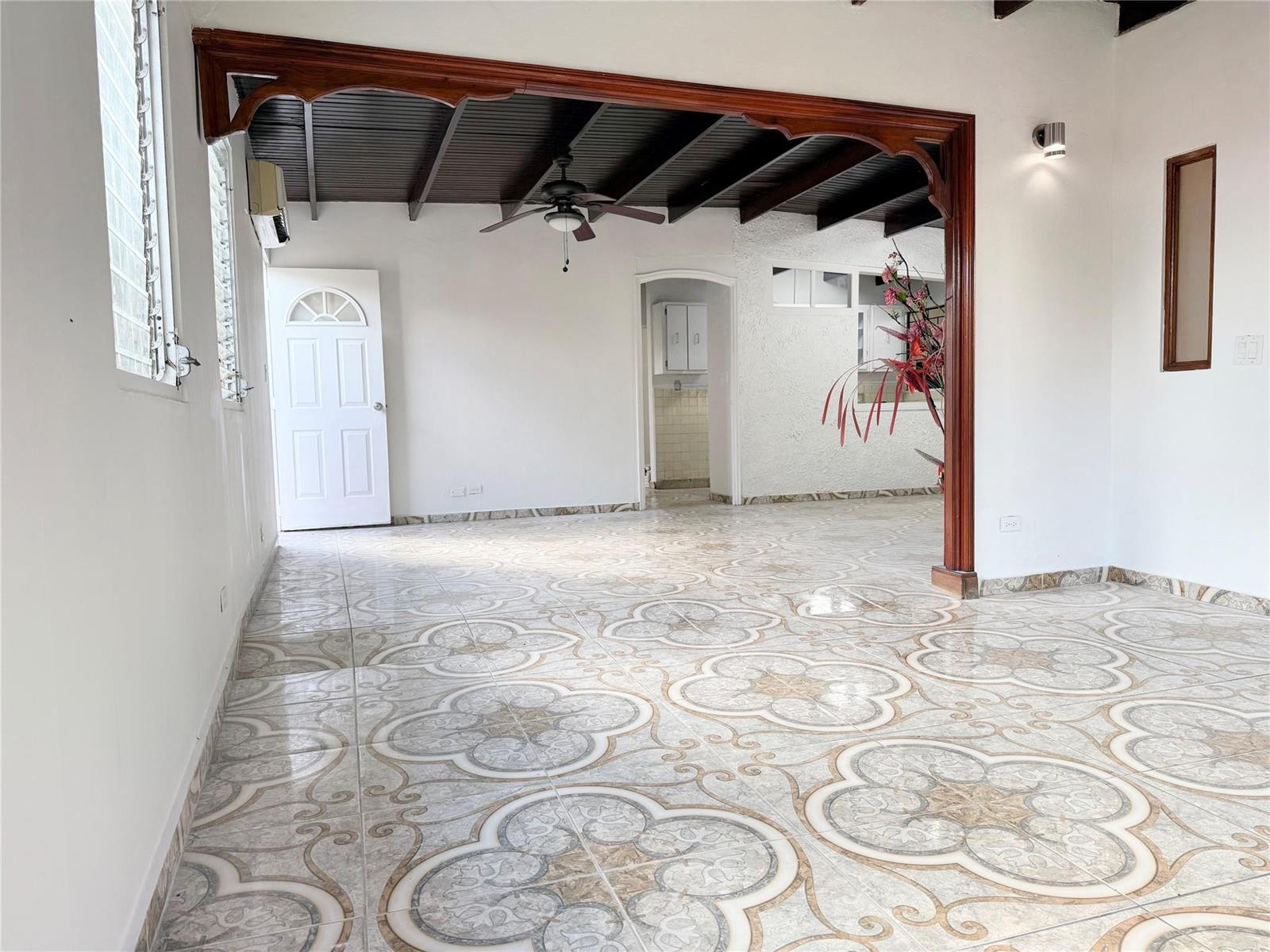 A room with patterned tile flooring, a dark wood-beamed ceiling, and a decorative wooden archway — Panama City, Panama N Panama City, PA, PA