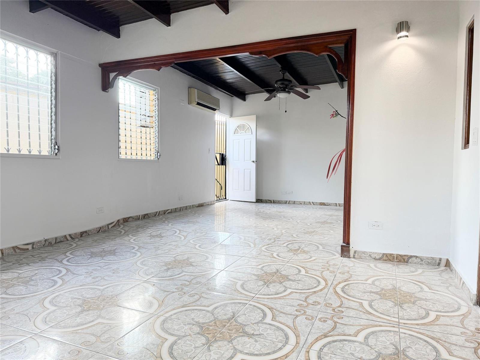 An interior room features patterned tile flooring, a dark wood-beamed ceiling, and a decorative archway — Panama City, Panama N Panama City, PA, PA