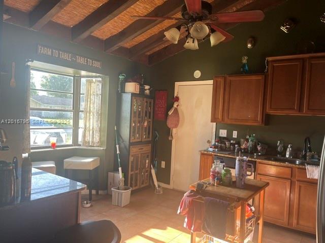 A kitchen features wooden cabinets, a ceiling fan, and a window with a dining nook — 5900 Bamboo Dr, Fort Pierce FL 34982, FORT PIERCE, FL