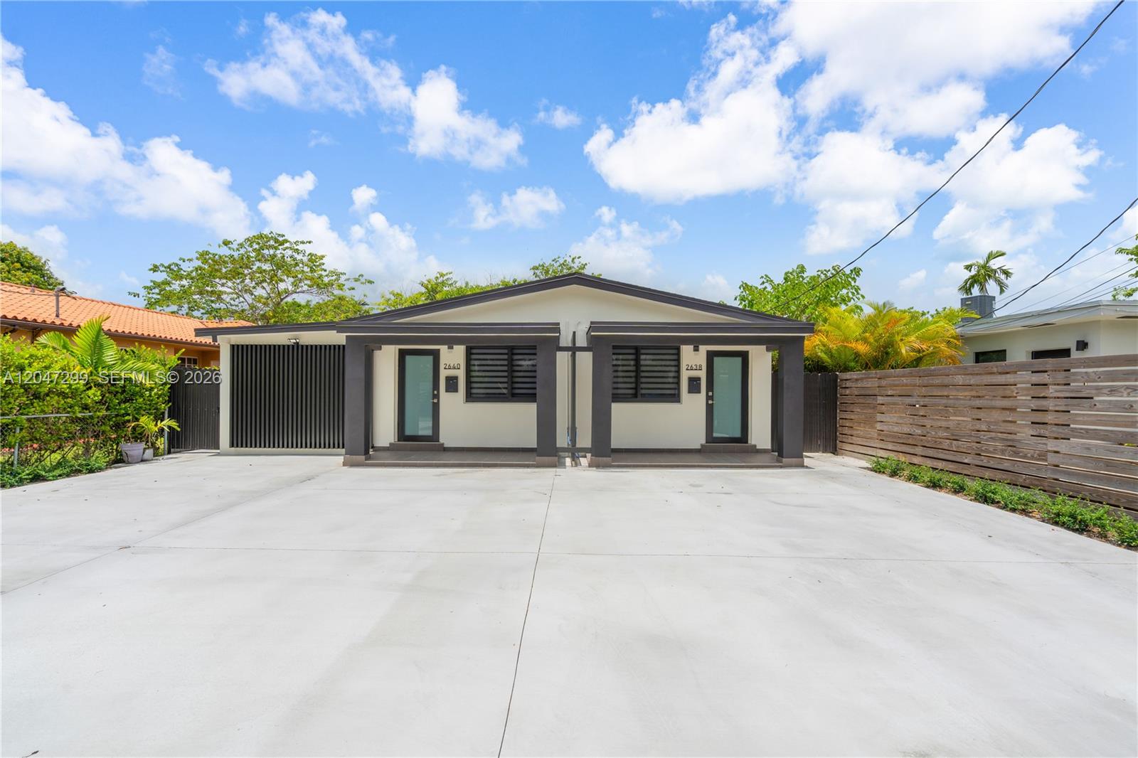 A modern duplex features a large concrete driveway and two identical front entrances — 2638 SW 30th Ct # 2638, Miami FL 33133, MIAMI, FL