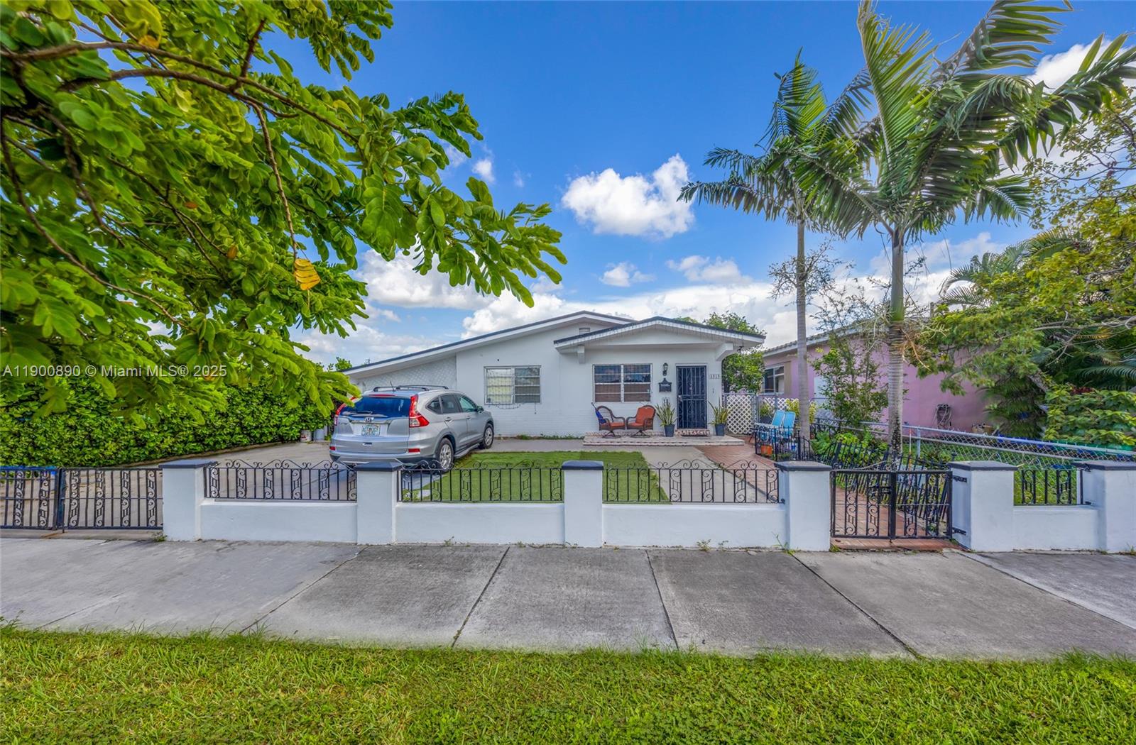 A single-story white house with a fenced front yard and a parked silver SUV — 1515 NW 33rd Ave, Miami FL 33125, MIAMI, FL