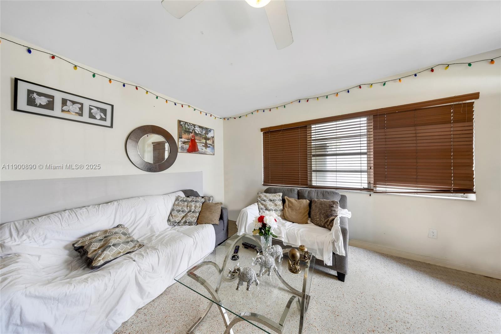 A living room features two sofas, a glass coffee table, and string lights on walls — 1515 NW 33rd Ave, Miami FL 33125, MIAMI, FL