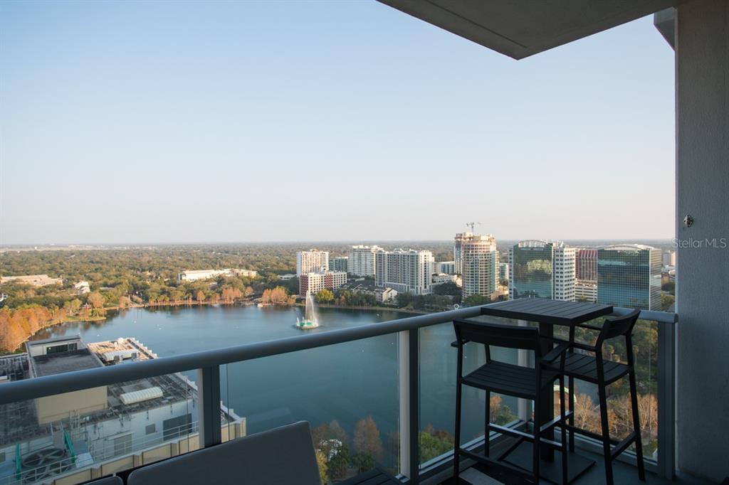 A high-rise balcony overlooks a lake with a fountain and a city skyline — 150 E ROBINSON STREET UNIT 2209, ORLANDO, FL