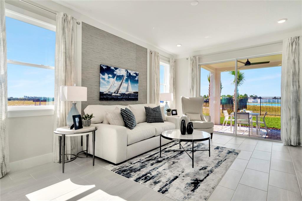 A modern kitchen features white cabinets, quartz countertops, a subway tile backsplash, and stainless appliances — 31856 CLOVER FIN COURT, WESLEY CHAPEL, FL