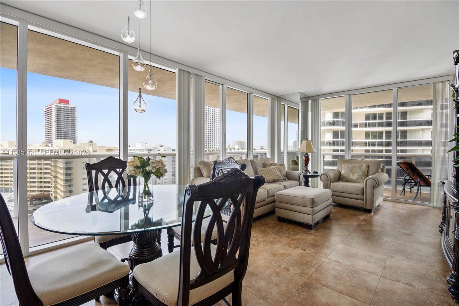 A dining and living area with floor-to-ceiling windows, tile floors, and a city view — 1830 S Ocean Dr # 1108, Hallandale Beach FL 33009, HALLANDALE BEACH, FL