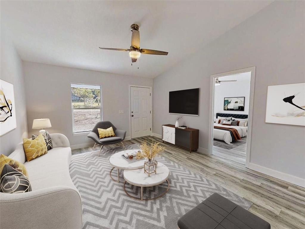 A living room features a white sofa, two round marble coffee tables, and a ceiling fan — 13163 SW 106TH PLACE, DUNNELLON, FL