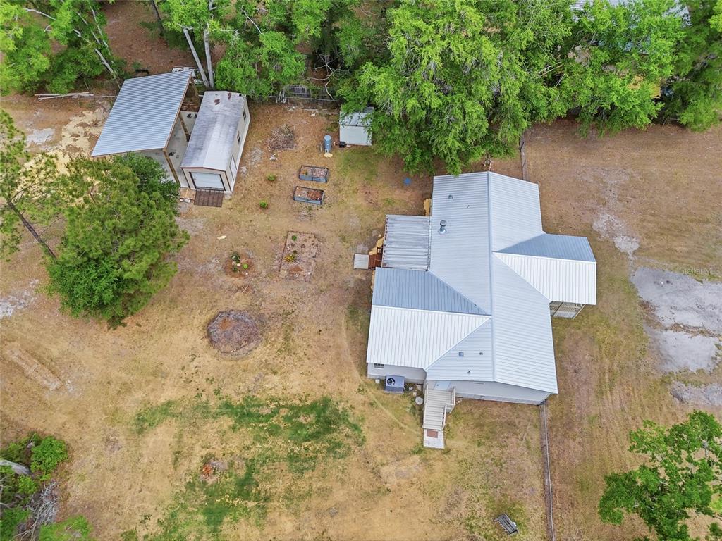 An aerial view shows a house with a metal roof, a shed, and a carport — 9528 NW 235TH TERRACE, ALACHUA, FL