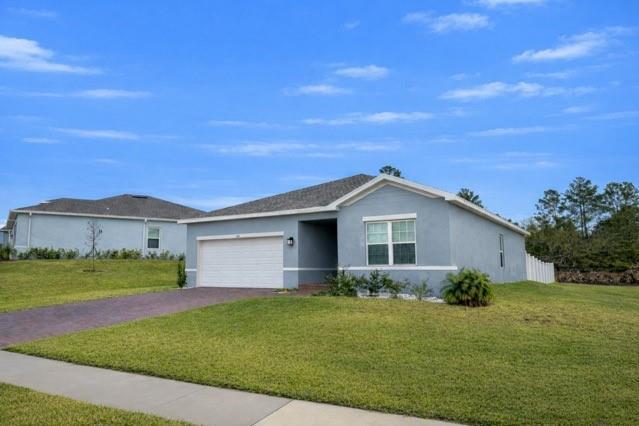 A light blue single-story house with a two-car garage and a paved driveway — 6740 Rumine Circle, Vero Beach FL 32967, VERO BEACH, FL