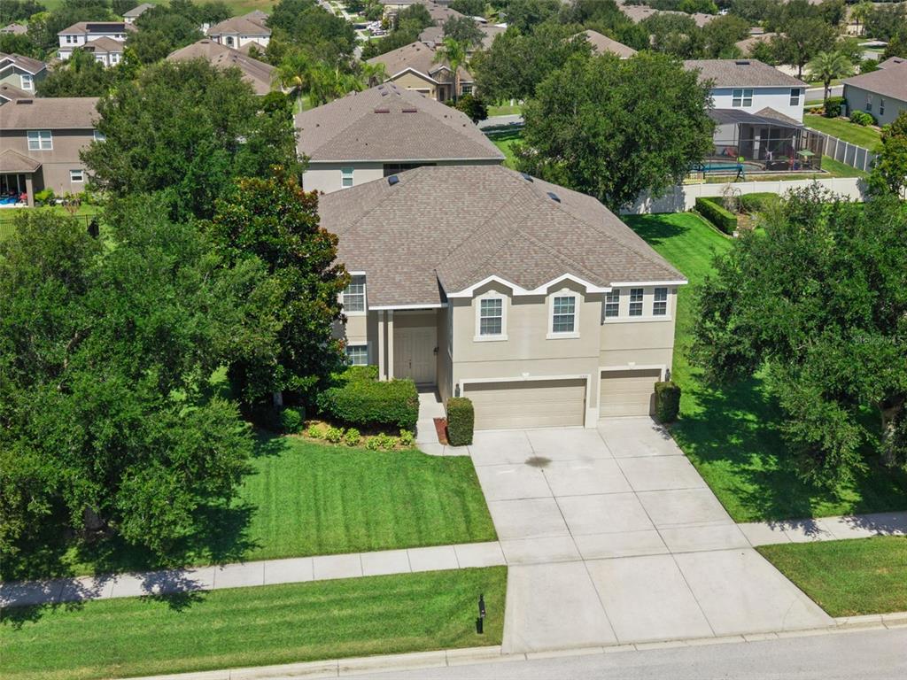 An aerial view of a two-story suburban house with a three-car garage and lawn — 11531 ARBOR GATE DRIVE, CLERMONT, FL