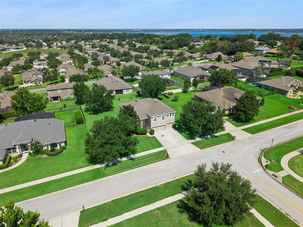 An aerial view of a suburban neighborhood featuring single-family homes with lawns and paved streets — 11531 ARBOR GATE DRIVE, CLERMONT, FL