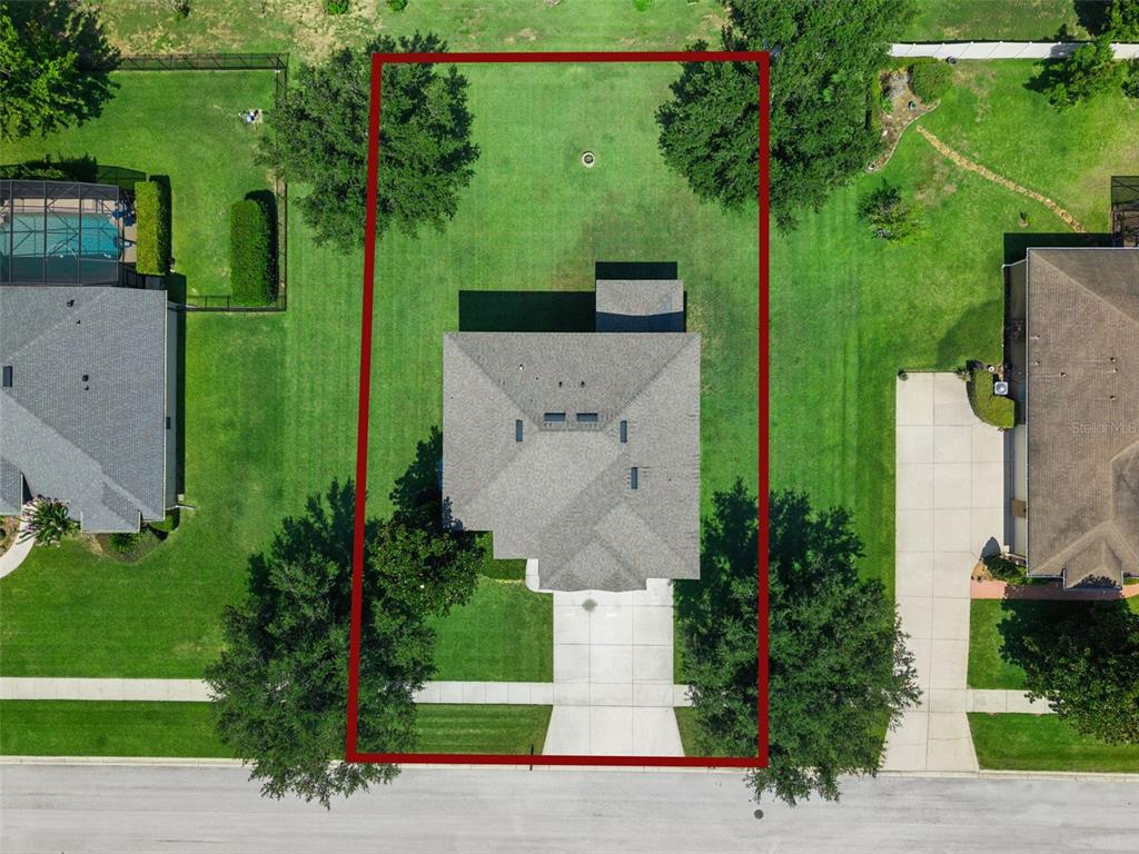 An aerial view shows a single-family home centered on a rectangular lot with a driveway — 11531 ARBOR GATE DRIVE, CLERMONT, FL
