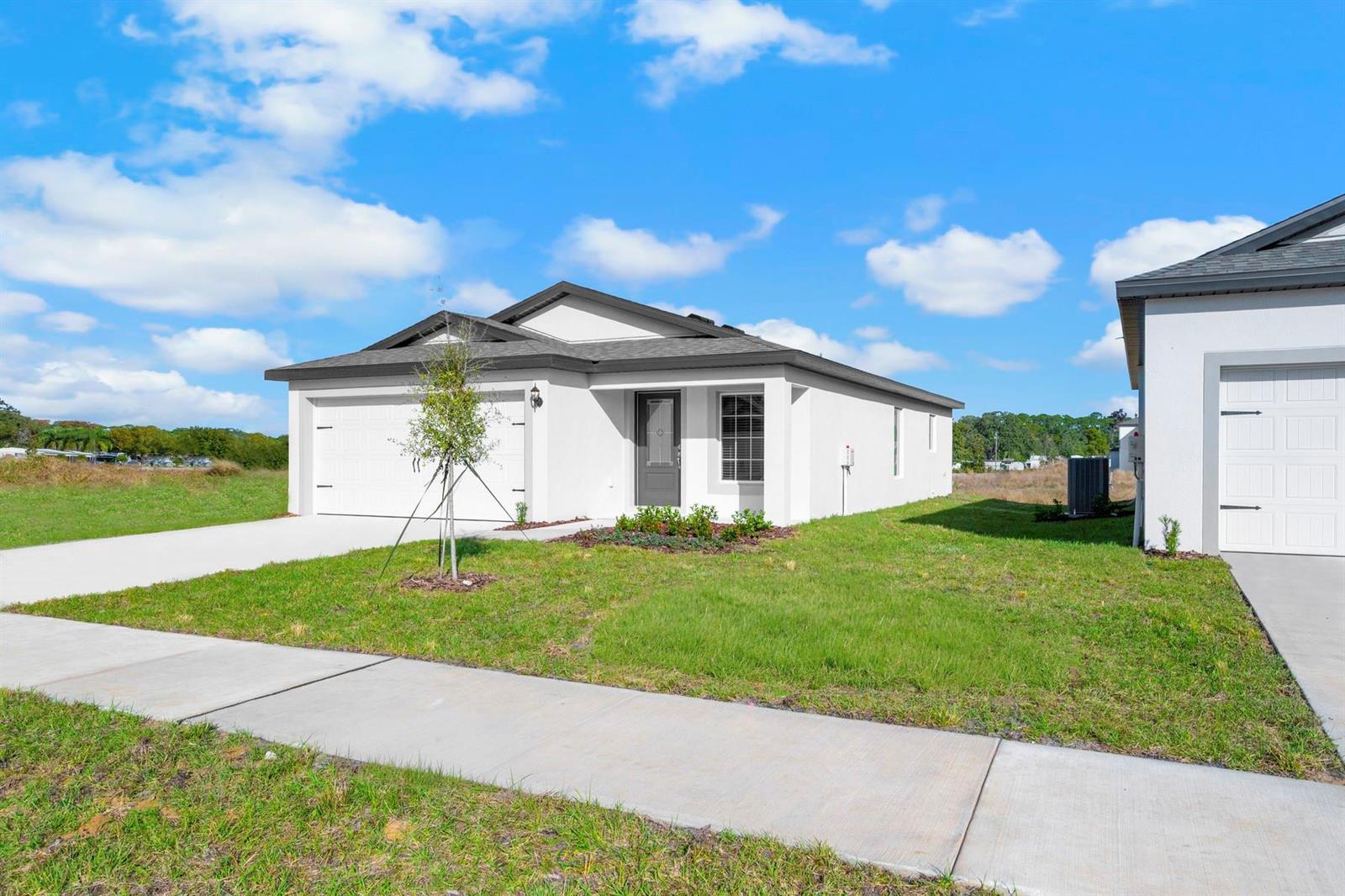 A single-story white house with a gray roof and a two-car garage — 8556 105th Avenue, Vero Beach FL 32967, VERO BEACH, FL