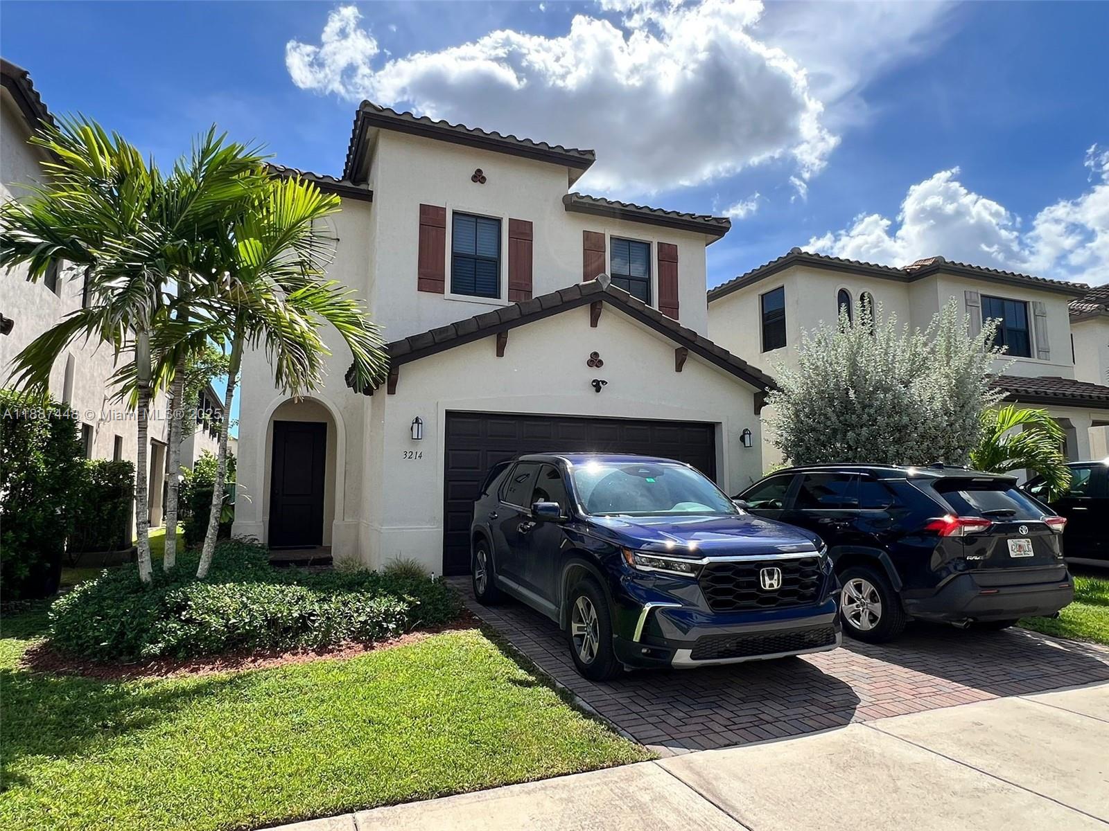 A two-story stucco house with a two-car garage and two parked SUVs in front — 3214 W 97th St, Hialeah FL 33018, HIALEAH, FL
