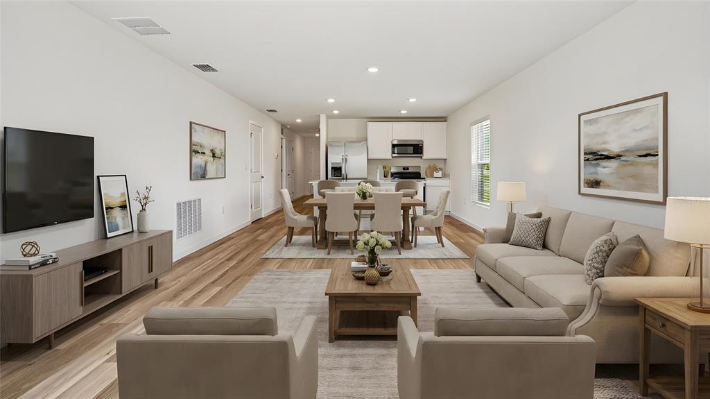 An open-concept living and dining area features light wood flooring and neutral-toned furniture — 7845 SW 46TH COURT, OCALA, FL