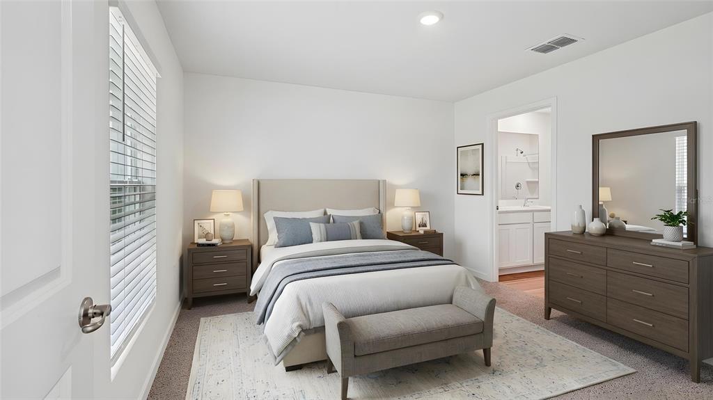 A bedroom features a bed with blue bedding, two nightstands, a dresser, and an attached bathroom — 7845 SW 46TH COURT, OCALA, FL
