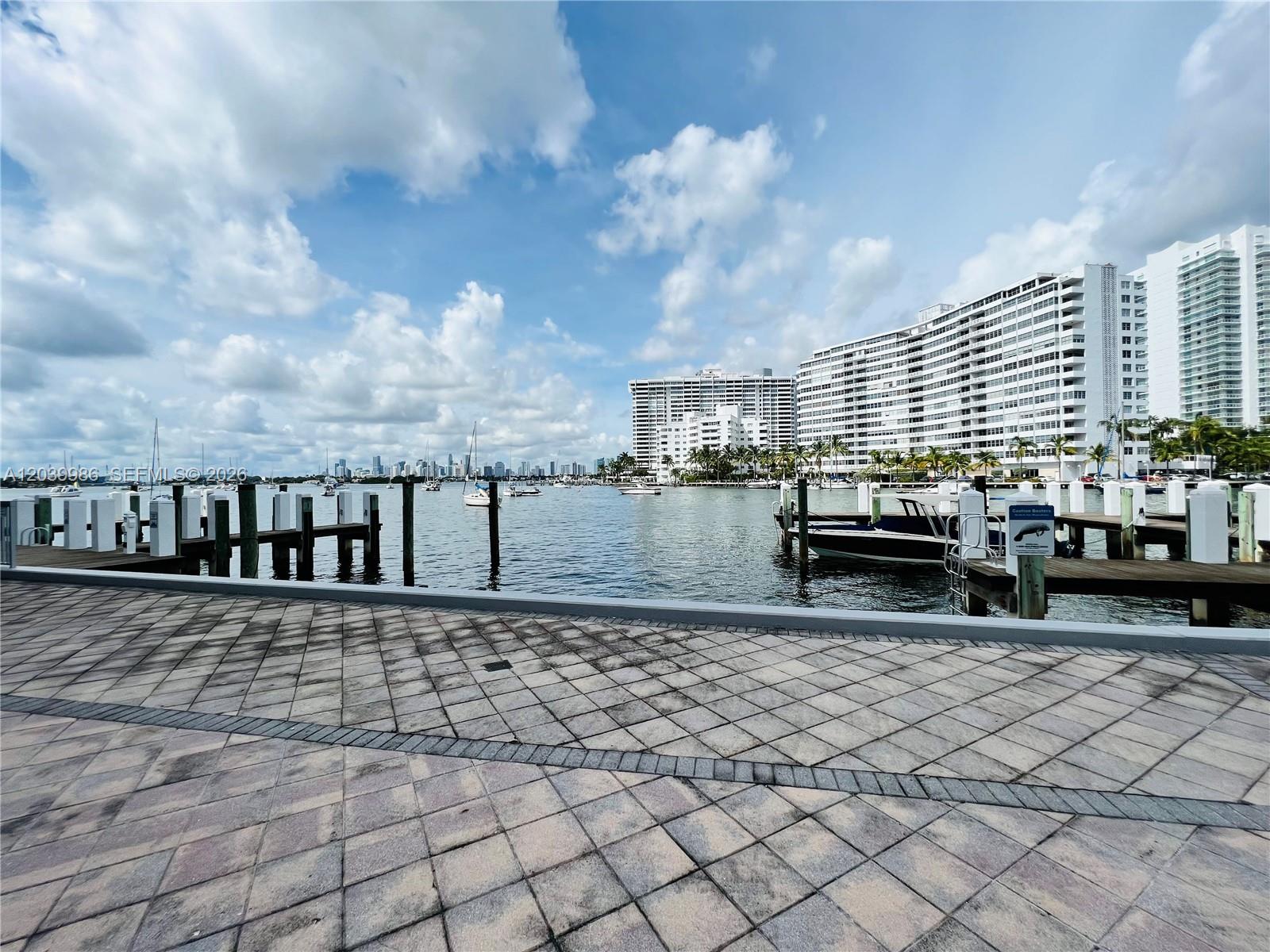A paved waterfront walkway overlooks a marina with boats and large apartment buildings — 1470 Lincoln Ter # 2, Miami Beach FL 33139, MIAMI BEACH, FL