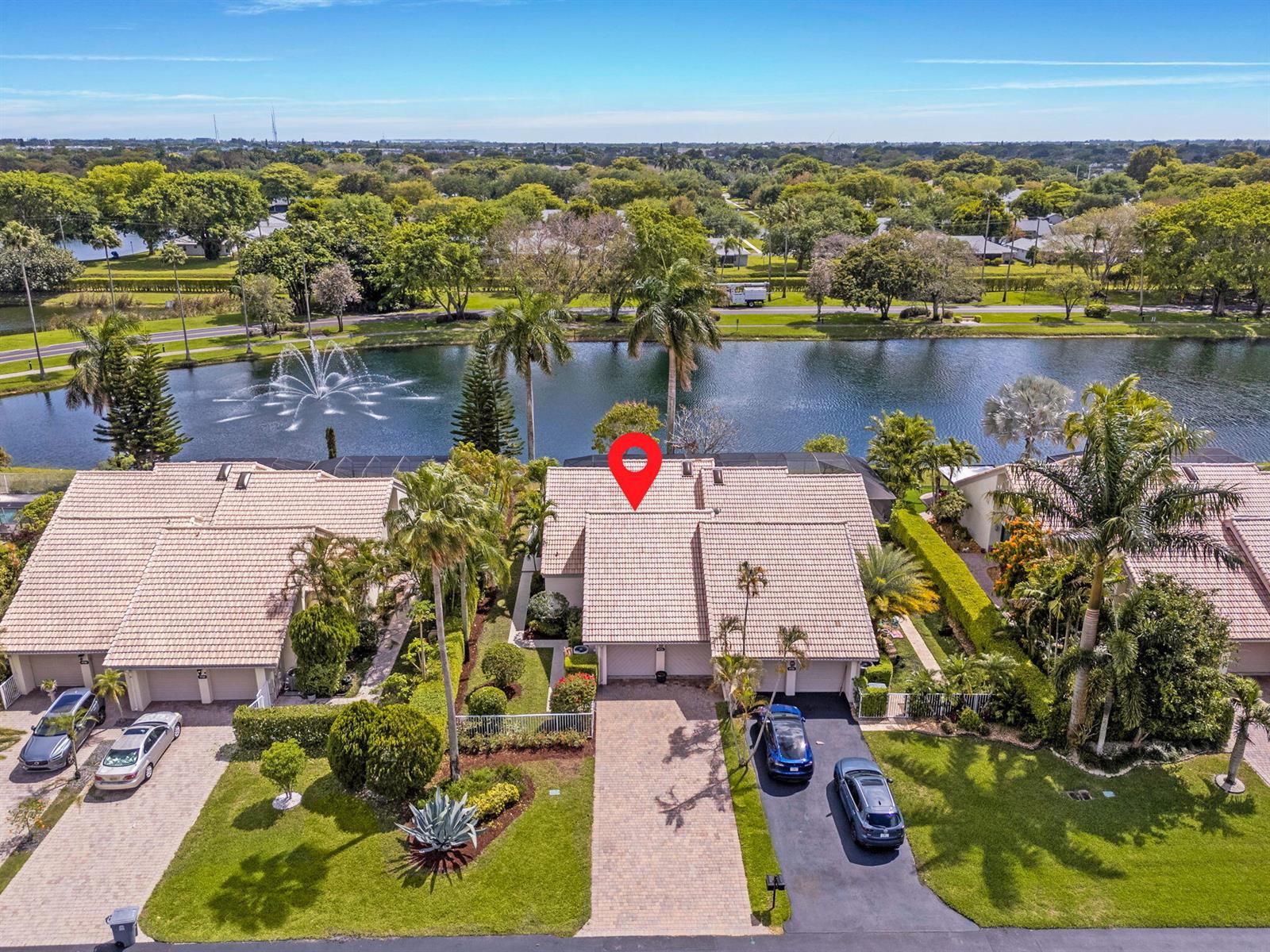 An aerial view shows two attached houses with tiled roofs, driveways, and a lake behind — 9722 Erica Court, Boca Raton FL 33496, BOCA RATON, FL