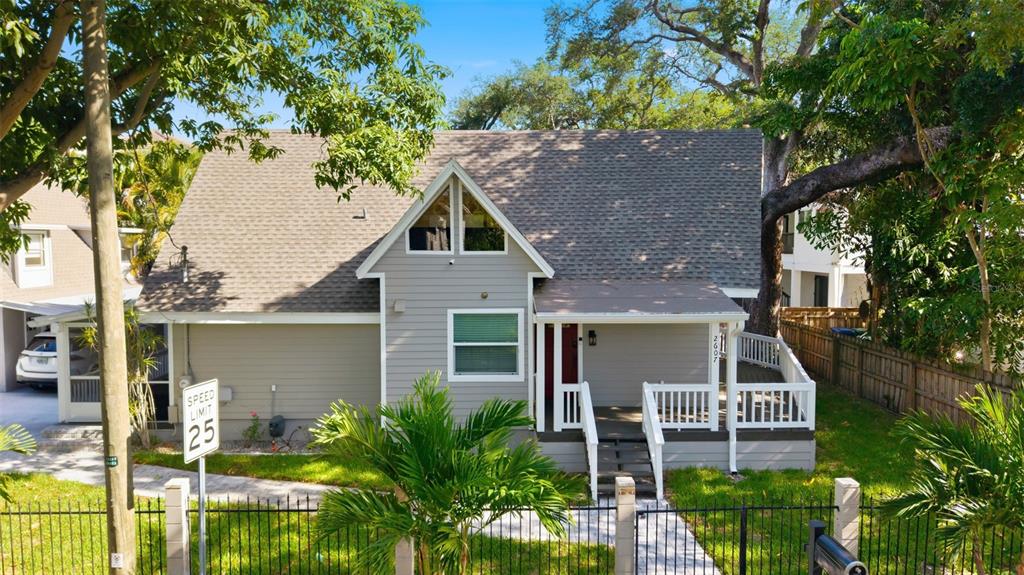 A gray house with a gabled roof, a front porch, and a fenced yard — 2607 W WYOMING AVENUE, TAMPA, FL