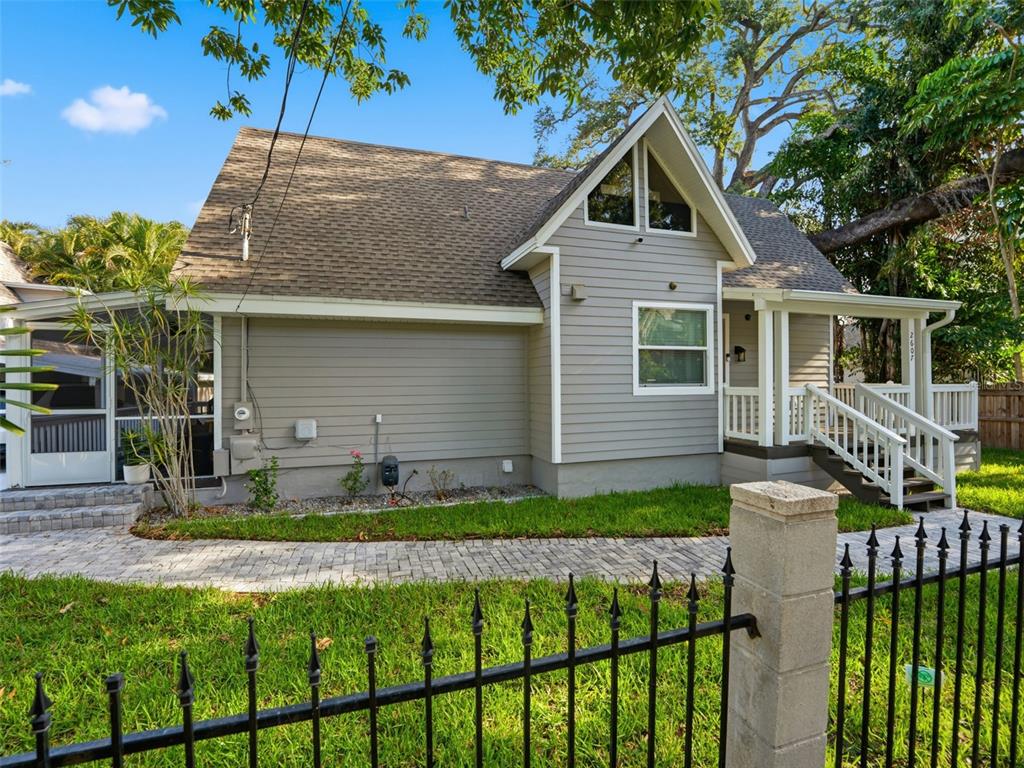 A gray house with a gabled roof, a front porch, and a brick walkway — 2607 W WYOMING AVENUE, TAMPA, FL