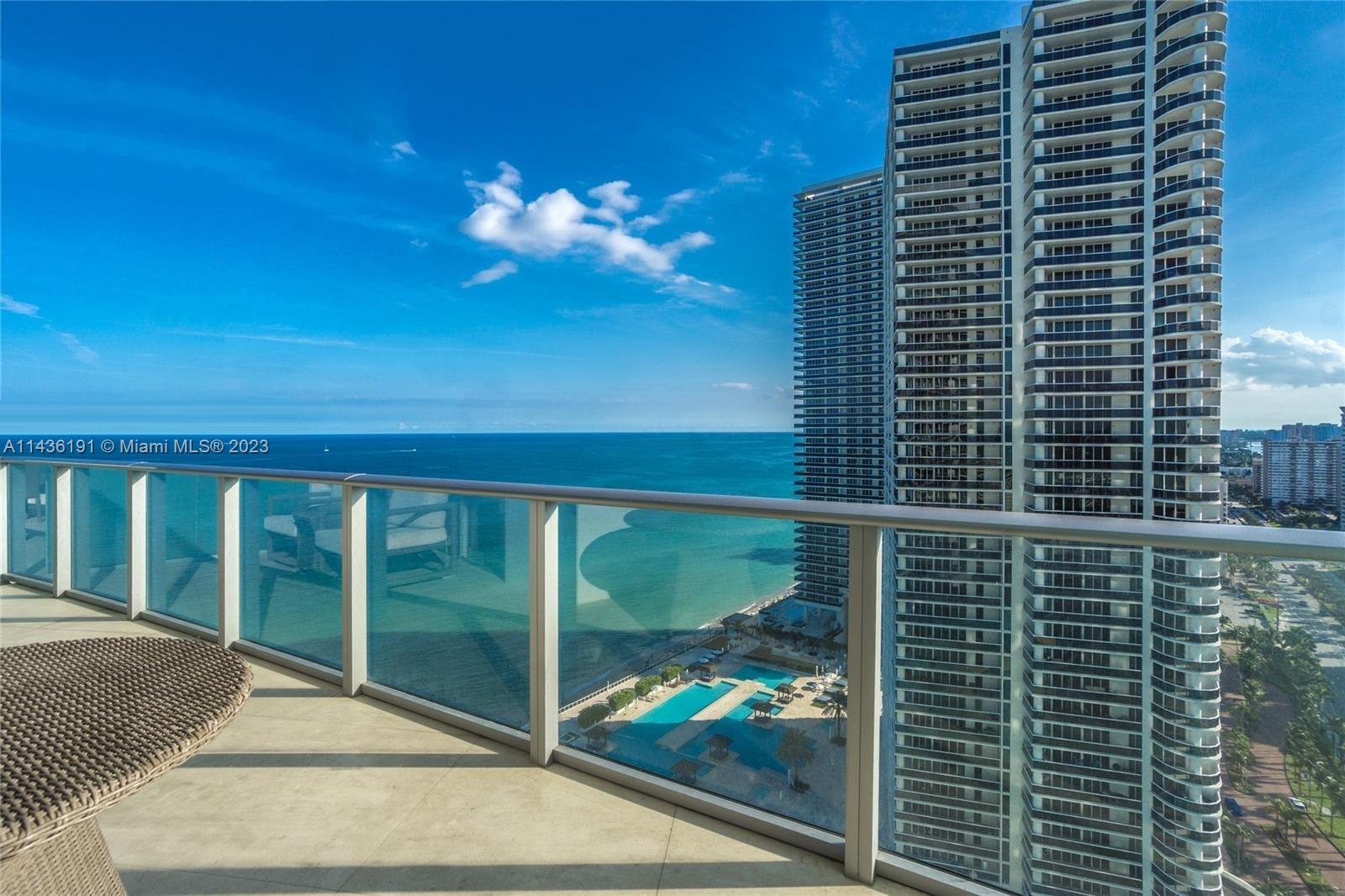 A high-rise balcony overlooks the ocean, a swimming pool area, and adjacent residential towers — 4111 S Ocean Dr # 2307, Hollywood FL 33019, HOLLYWOOD, FL