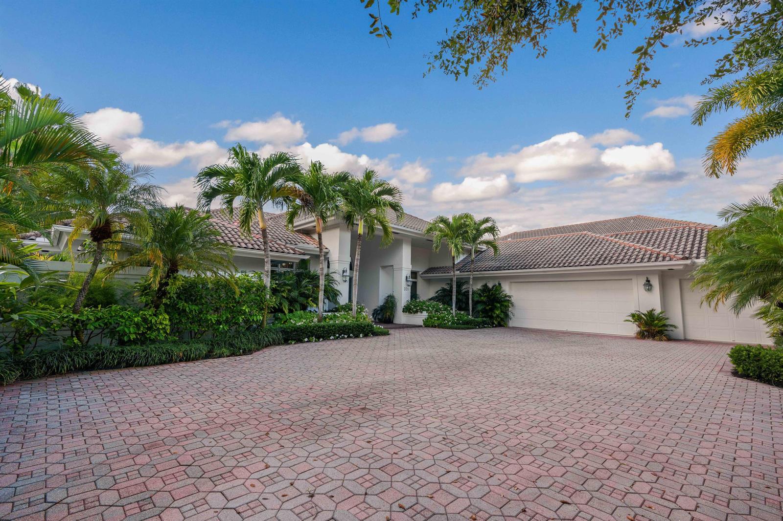 A single-story house with a tiled roof, palm trees, and a large paved driveway — 351 Eagle Drive, Jupiter FL 33477, JUPITER, FL