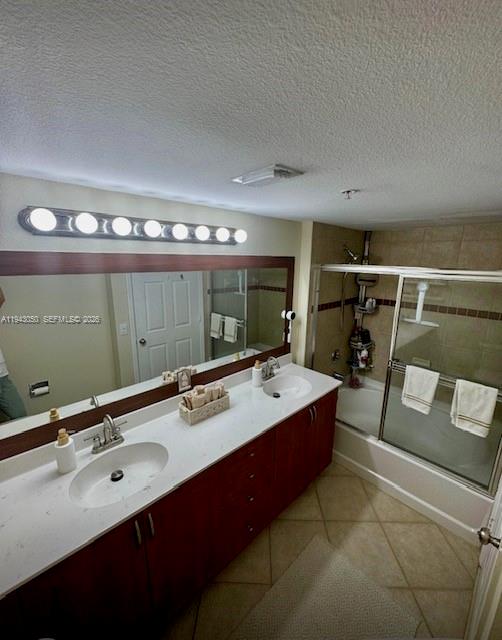 A bathroom features a double vanity with a white countertop, wood cabinets, and a shower-tub — 6434 Emerald Dunes Dr # 304, West Palm Beach FL 33411, WEST PALM BEACH, FL