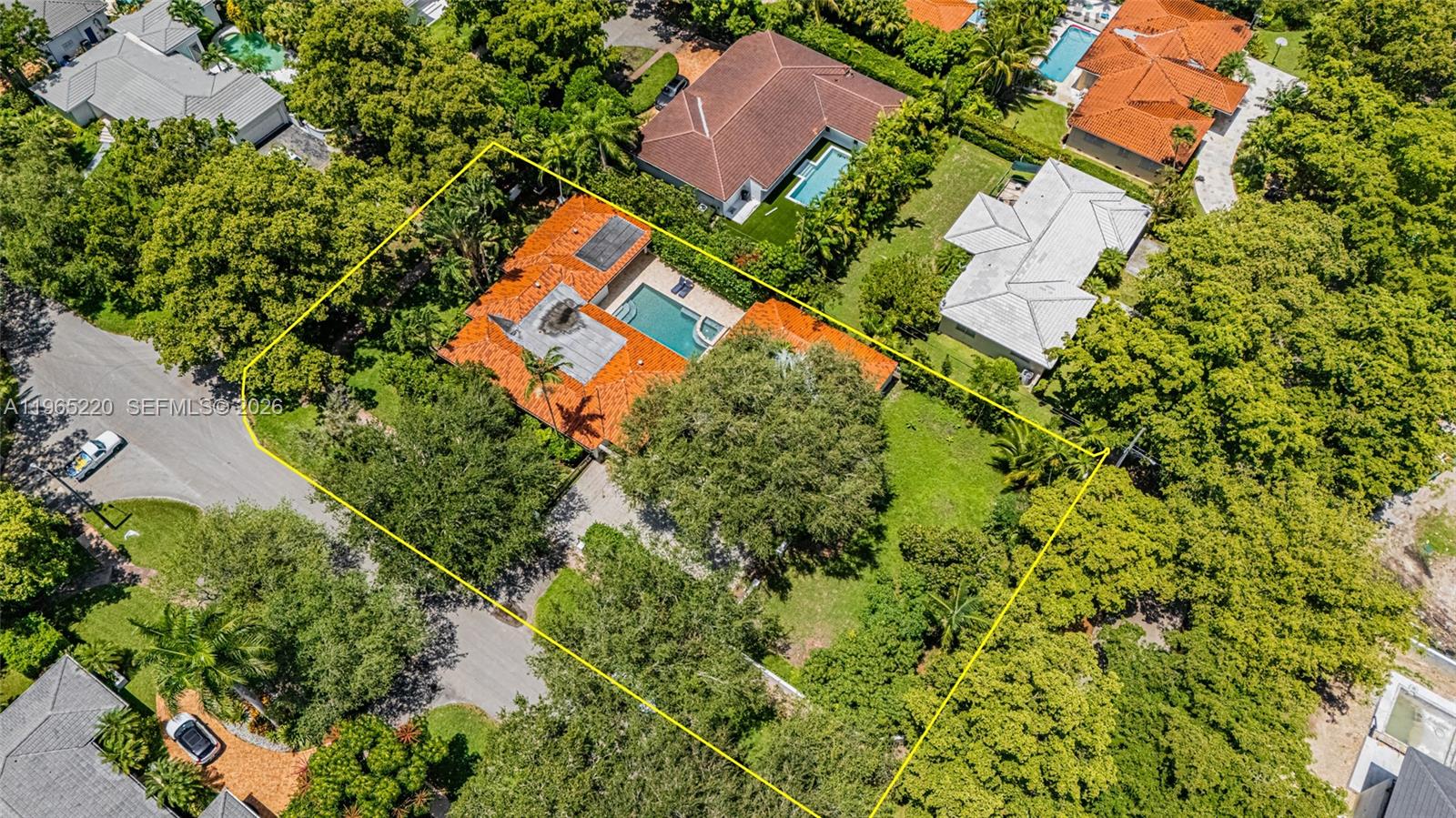 An aerial view shows a house with a tile roof, pool, and large yard — 5810 Maggiore St # 0, Coral Gables FL 33146, CORAL GABLES, FL