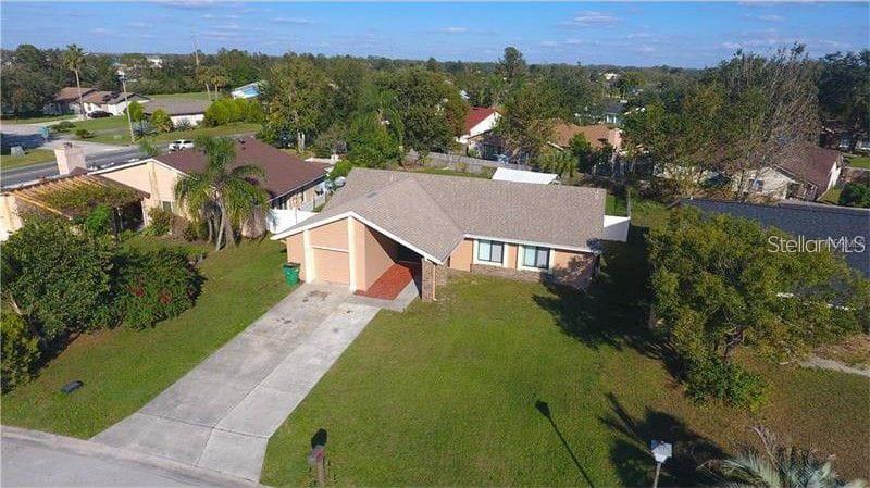 A single-story light blue house with a front-facing garage and a concrete driveway — 3 COUNTRY CLUB COURT, KISSIMMEE, FL