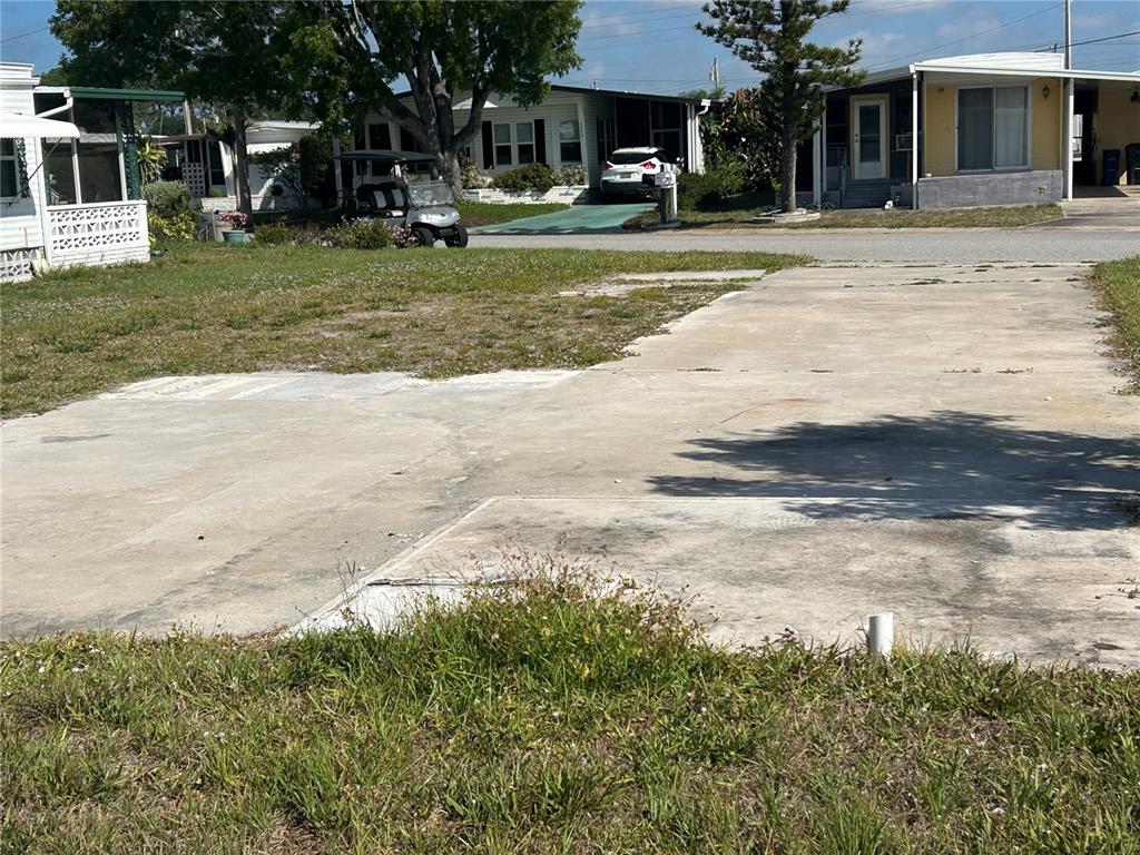 A vacant concrete lot sits in a residential neighborhood with neighboring mobile homes — 1792 MIDLOTHIAN STREET, SARASOTA, FL