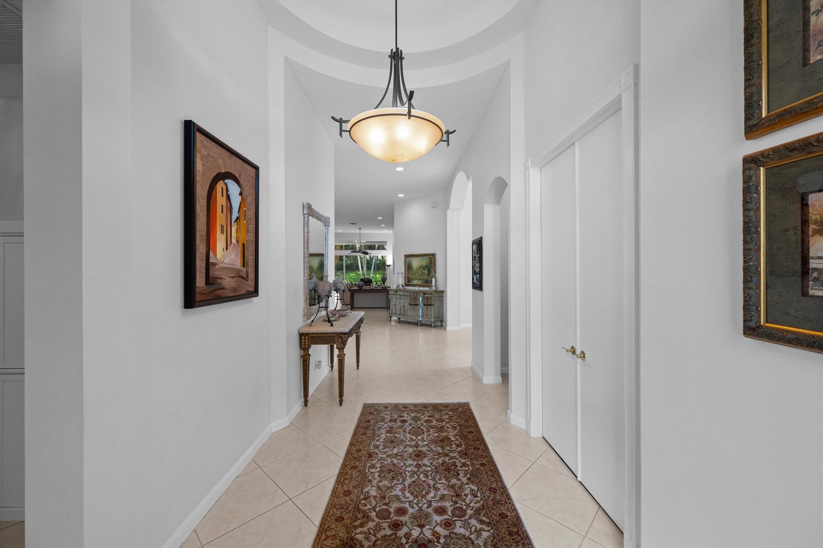 A bright hallway features a domed ceiling, a pendant light, and a patterned area rug — 10689 Northgreen Drive, Lake Worth FL 33449, LAKE WORTH, FL