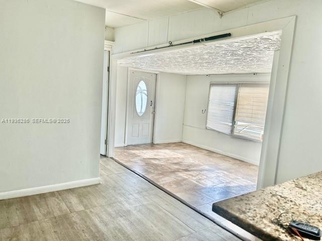 An interior view shows a tiled room with a white door and large windows — 8732 SW 16th St, Davie FL 33324, DAVIE, FL