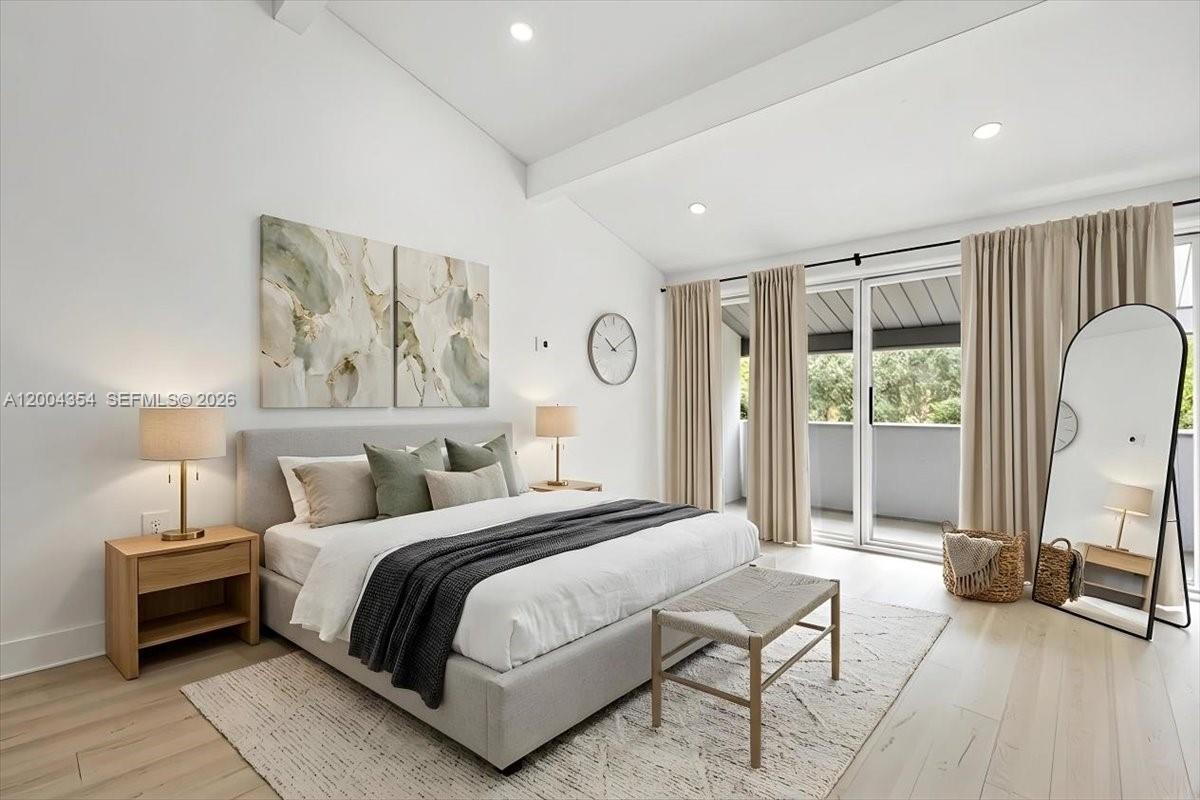 A modern bedroom features a king bed, neutral decor, and a sliding glass balcony door — 19220 NE 25th Ave # 274B, Miami FL 33180, MIAMI, FL