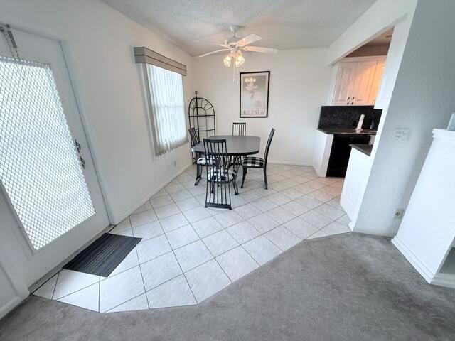 A dining area features a round table, four chairs, tile flooring, and a ceiling fan — 4065 Harwood E, Deerfield Beach FL 33442, DEERFIELD BEACH, FL