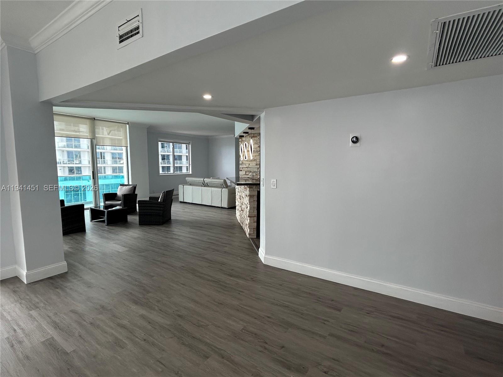 An elevated view shows a sandy beach, ocean, and modern high-rise buildings — 4001 S Ocean Dr, Hollywood FL 33019, HOLLYWOOD, FL