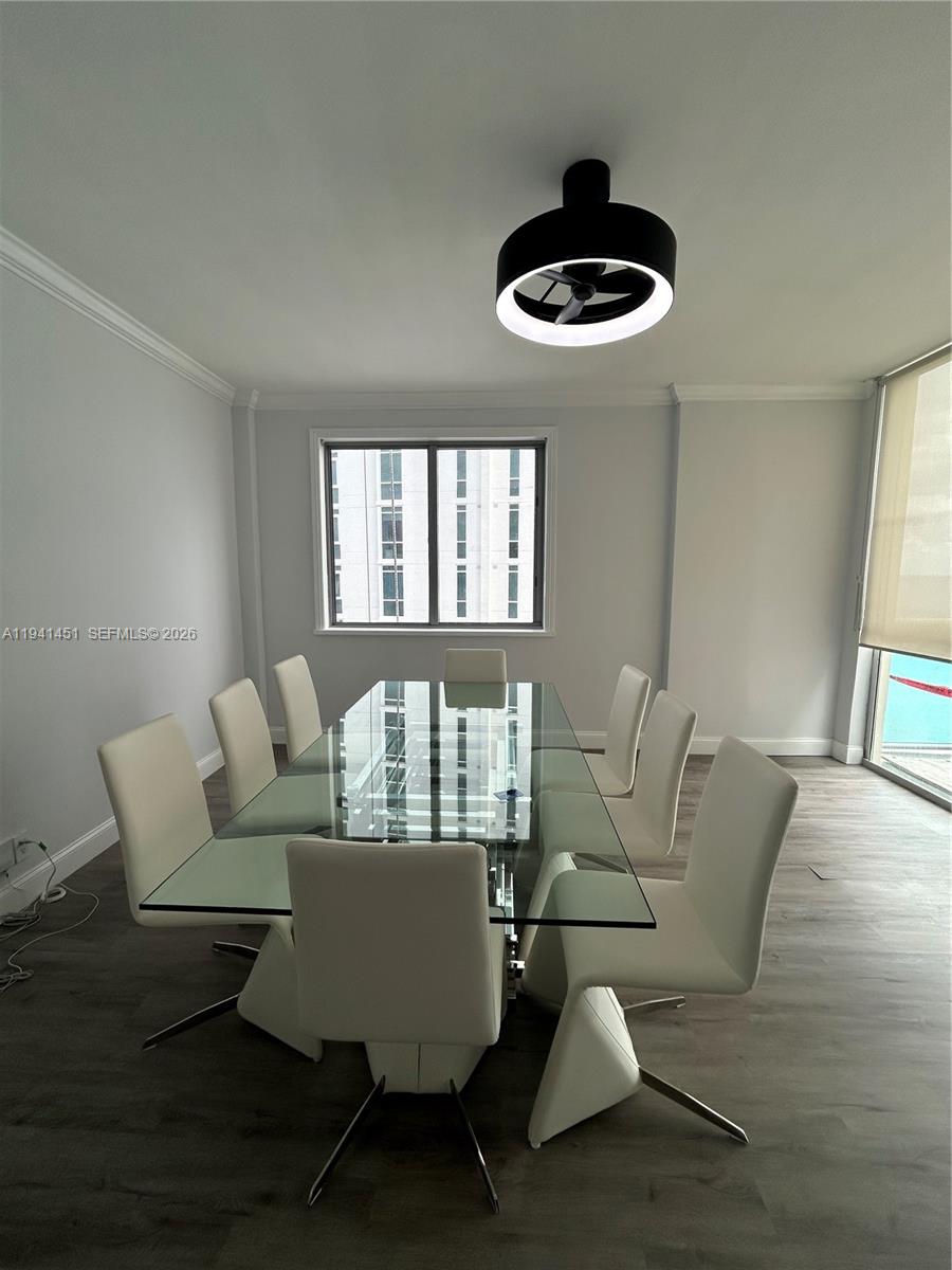 An open-concept living area features light gray walls, wood-look flooring, and a stone-accented bar — 4001 S Ocean Dr, Hollywood FL 33019, HOLLYWOOD, FL