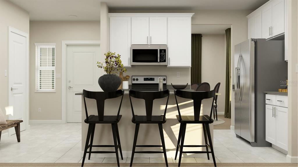 This is a digital rendering of a kitchen featuring white cabinets, stainless appliances, and bar seating — 6071 WELLBEING WAY, CLERMONT, FL