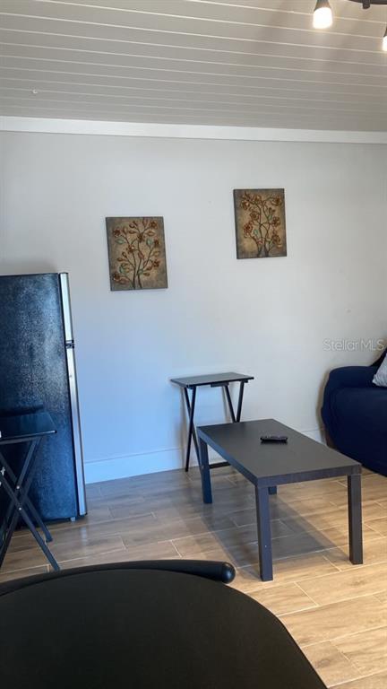 A white door with a large glass insert opens to a view of a parked car — 9921 VAUGHN STREET UNIT 2 Bd, GIBSONTON, FL