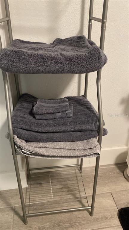 A black metal bunk bed with blue and gray bedding sits in a bedroom — 9921 VAUGHN STREET UNIT 2 Bd, GIBSONTON, FL