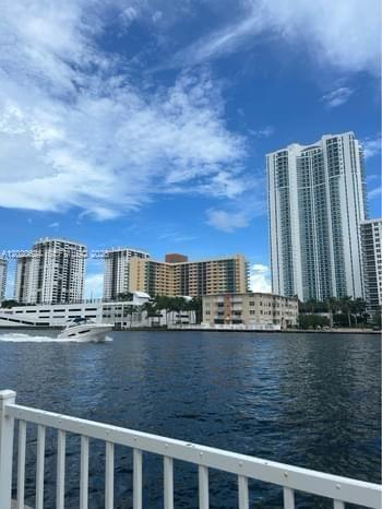 A white boat travels on a waterway in front of several high-rise apartment buildings — 800 Parkview Dr # 406, Hallandale Beach FL 33009, HALLANDALE BEACH, FL