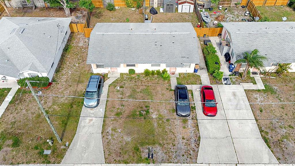 An aerial view shows a duplex with gray shingled roofs and concrete driveways — 6524/6526 12TH STREET W, BRADENTON, FL