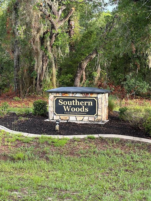A stone monument sign for Southern Woods stands in a landscaped area with trees — 2 BARKWOOD POINT, HOMOSASSA, FL