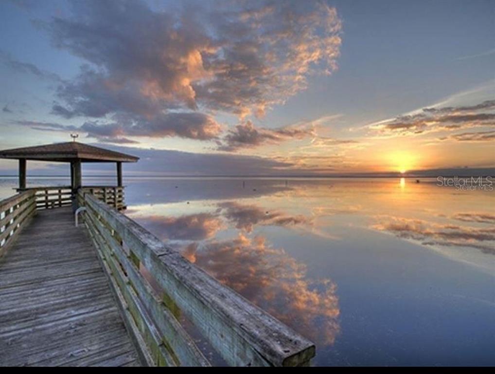 A wooden pier with a gazebo extends into a calm lake at sunset — 731 PARADISE BOULEVARD, GEORGETOWN, FL