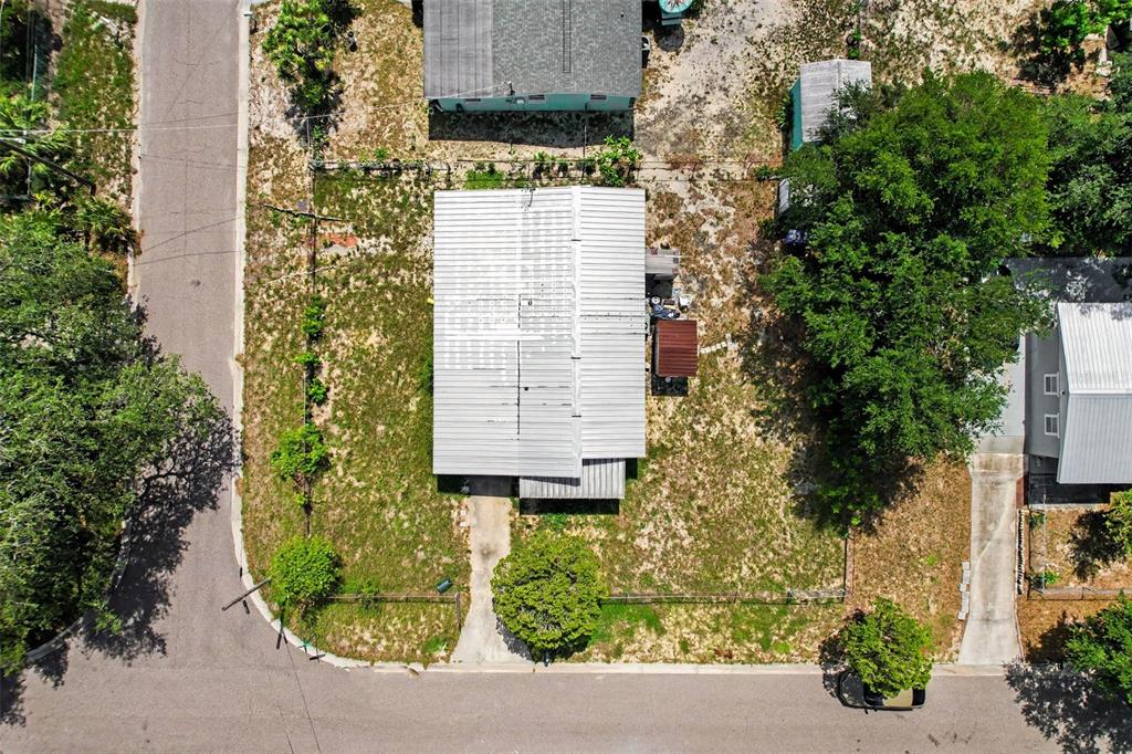 An aerial view shows a rectangular house with a metal roof on a grassy lot — 4503 N 72ND STREET, TAMPA, FL