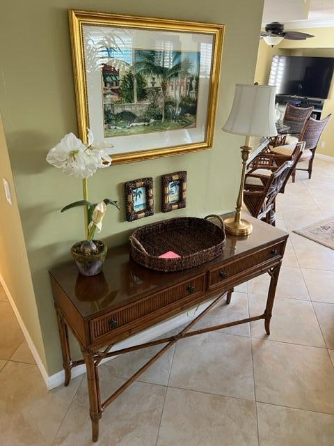 A wooden console table with a lamp and decor sits against a green wall — 1605 S Us Highway 1 # A301, Jupiter FL 33477, JUPITER, FL