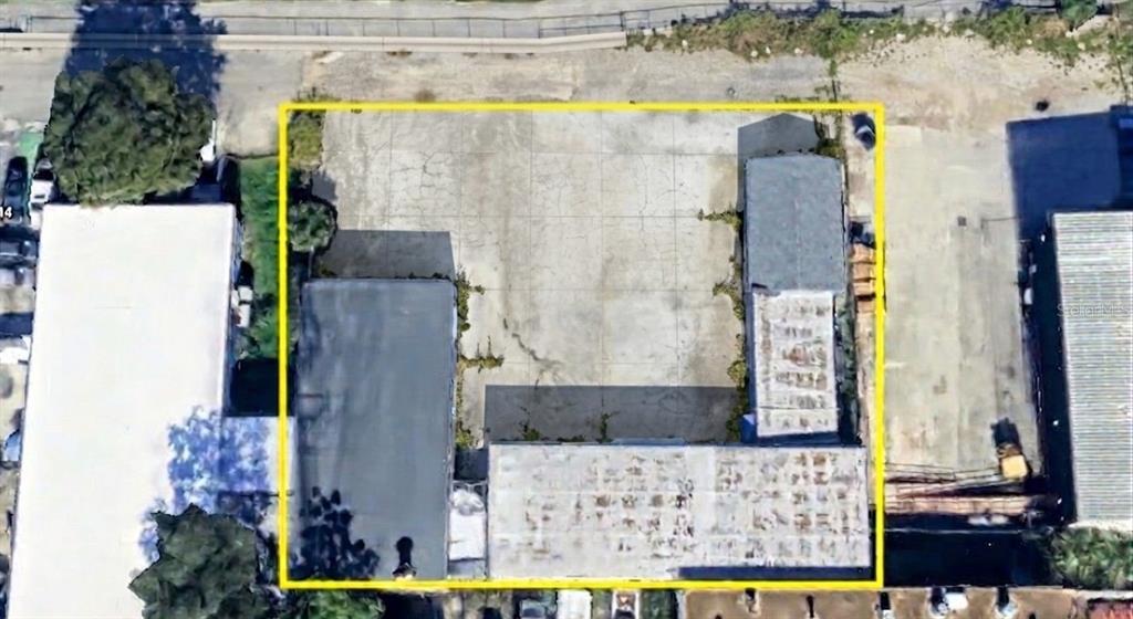 This aerial view shows a rectangular lot with two flat-roofed buildings and a paved courtyard — 4120 ROUSH AVENUE, ORLANDO, FL