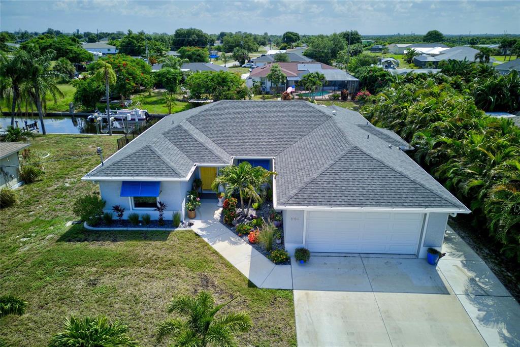 An aerial view shows a house with a red location pin along a canal — 3104 SEAFARER DRIVE, PUNTA GORDA, FL