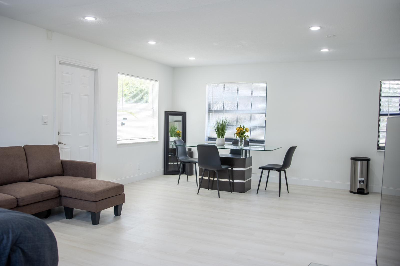 A bright living and dining area with white walls, light flooring, and modern furniture — 320 NW 4th Avenue # 3, Deerfield Beach FL 33441, DEERFIELD BEACH, FL