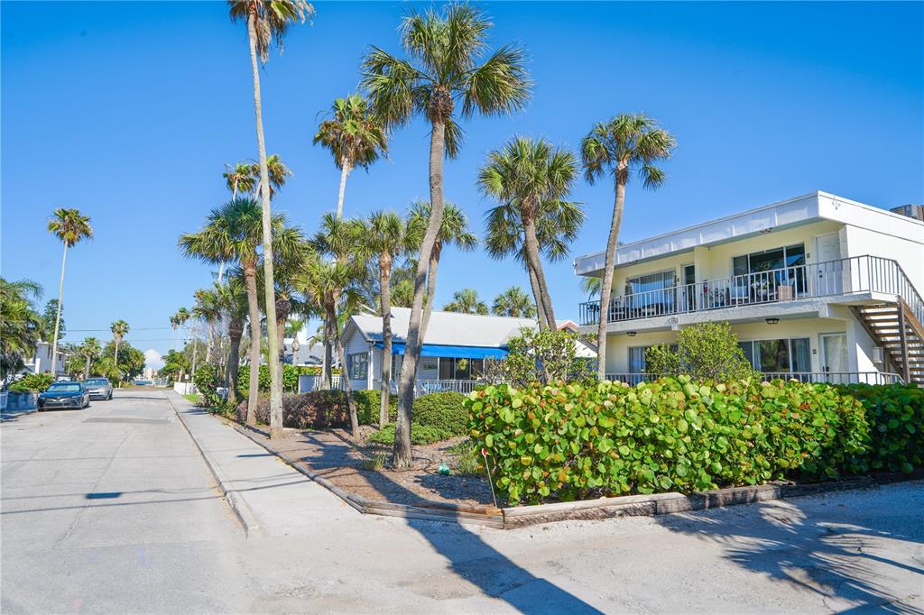 A street view shows a two-story building and a cottage surrounded by palm trees — 108 14TH AVENUE UNIT 2, ST PETE BEACH, FL
