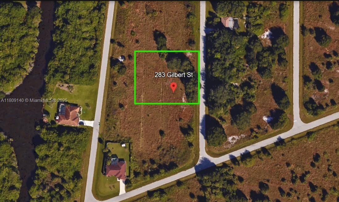 An aerial view of a vacant, rectangular plot of land outlined in green — 283 Gilbert St, Port Charlotte FL 33954, PORT CHARLOTTE, FL